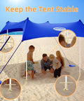 Go To Beach Tent Sand Anchors And Ground Stakes Set in use on a beach with family under a canopy