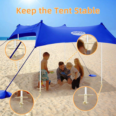 Go To Beach Tent Sand Anchors And Ground Stakes Set in use on a beach with family under a canopy