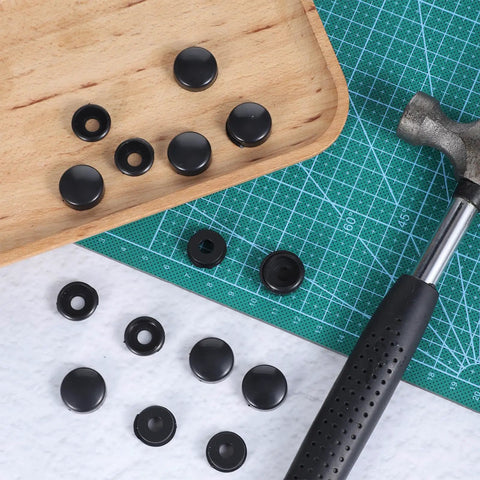 Top view of Black License Plate Screw Cap Kit With Eight Caps For Frame Bolts, universal fit, and installation tool on grid mat