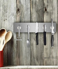 Heavy Duty Neodymium Disc Magnets 6 Pack With Double Sided Adhesive Backing holding kitchen utensils on a metal strip.