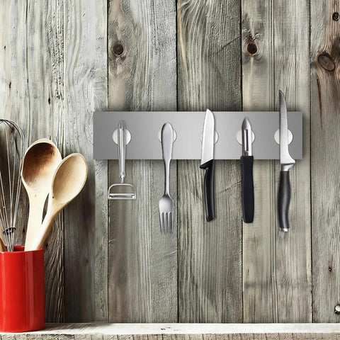 Heavy Duty Neodymium Disc Magnets 6 Pack With Double Sided Adhesive Backing holding kitchen utensils on a metal strip.