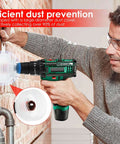 Side view of green and black cordless drill with white dust-collection guard attached, drilling into brick.