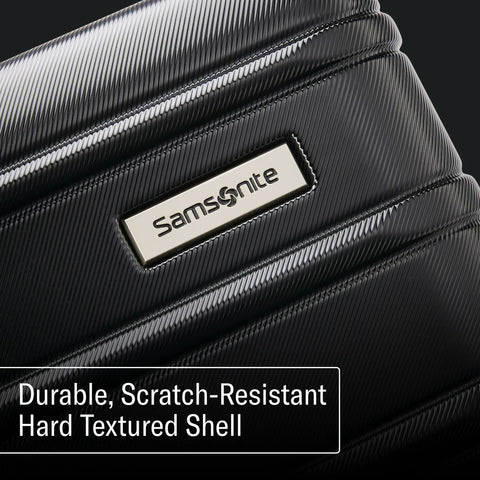 Samsonite Omni 2 hardside luggage close-up of textured black shell with metal logo plate