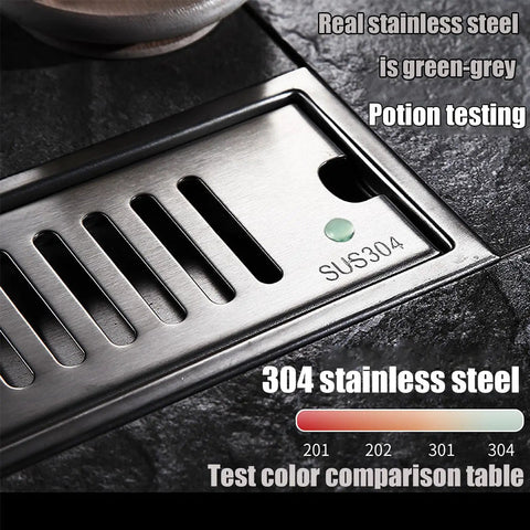 Slick Linear Shower Floor Drain With Hair Strainer For No Sweat Bathroom Water Flow Crafted From Heavy Duty 304 Stainless Steel Featuring A Smooth Brushed Finish, close-up of stainless steel drain with green test dot.
