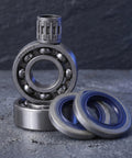Chainsaw Crankshaft Bearing And Rubber Oil Seal Set For High Speed Transmission, Needle Roller Bearing Kit, Saw Repair For Gasoline Power Saws, Heavy Duty Pro Grade Sealing System For Tight Seal And Leak Free Performance. Close-up of bearing and blue rubber seals