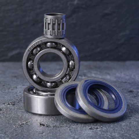 Chainsaw Crankshaft Bearing And Rubber Oil Seal Set For High Speed Transmission, Needle Roller Bearing Kit, Saw Repair For Gasoline Power Saws, Heavy Duty Pro Grade Sealing System For Tight Seal And Leak Free Performance. Close-up of bearing and blue rubber seals