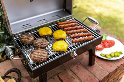 Single Burner Portable Propane Grill With Piezo Ignition, Stainless Steel, showing burgers and hot dogs cooking evenly outdoors