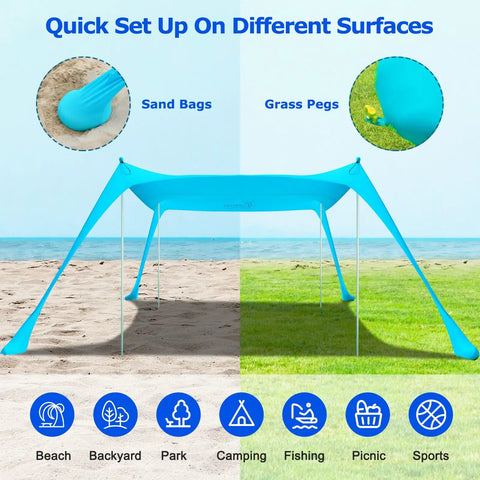 Beach Tent Sun Shelter 10x10ft Pop Up Canopy With UPF50 Plus Shade, shown set up on sand with sandbags and grass with stakes.