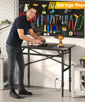 Man using Space Saving 1000 Pound Metal Work Bench for Garage with 38.58 Inch Adjustable Height Table and Built-In Power Strip.