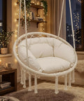 Hanging Hammock Chair With Cozy Full Cushion For Indoor Outdoor Relaxation, white macrame swing with large plush cushion inside a decorated room.