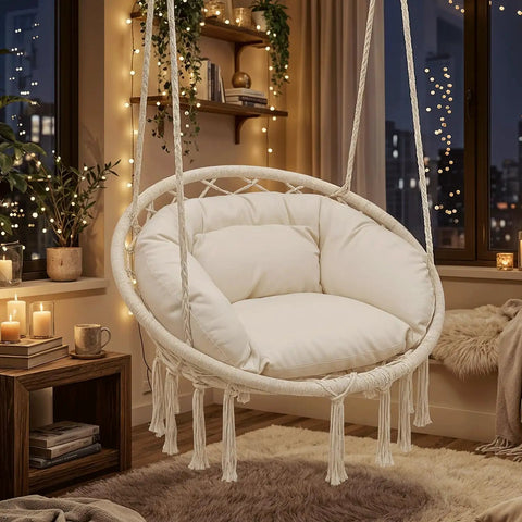 Hanging Hammock Chair With Cozy Full Cushion For Indoor Outdoor Relaxation, white macrame swing with large plush cushion inside a decorated room.