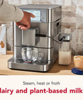 Sleek And Straight Up Fully Automatic Espresso Machine With Removable Bean Hopper One Touch Frothing System Forty Plus Barista Grade Cups Smooth Stainless Steel Housing For Daily Use, showing touch screen and frothing attachment.