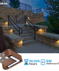 Lit Right Angle Outdoor Step Lights 8 Pack for Corners and Walls illuminating outdoor stone stairs at night, bronze finish.