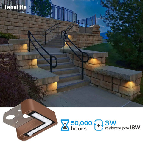 Lit Right Angle Outdoor Step Lights 8 Pack for Corners and Walls illuminating outdoor stone stairs at night, bronze finish.