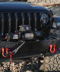 Pro Series 13500 Lb 12V Electric Winch With Synthetic Rope, 2 In 1 Wired And Wireless Remote, IP67 Waterproof, 7 HP Motor, Heavy Duty Recovery For Jeep SUV Truck And Trailer installed on Jeep front bumper