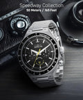 Run The Street With This Badass 44 Mm Men's Watch Featuring A Gearshift Inspired Face Premium Stainless Steel Bracelet And Bold Black Dial For Daily Quartz Performance, displayed on a dark surface with vintage camera.