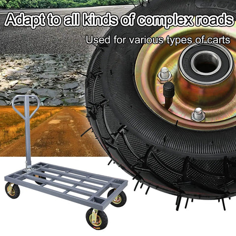 Close-up of heavy duty rubber caster wheel with rugged tread on a gray industrial trolley for work on rough surfaces.