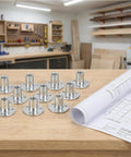 10 Pack Badass M12 T Nuts Built Tough With Rock Solid Zinc Plated Carbon Steel and Wide Round Base on a wooden workbench.