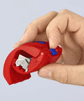 Hand holding BiX Pipe Cutter for 3/4 Inch to 2 Inch Pipes, showing reversible blade head and red and blue handle.