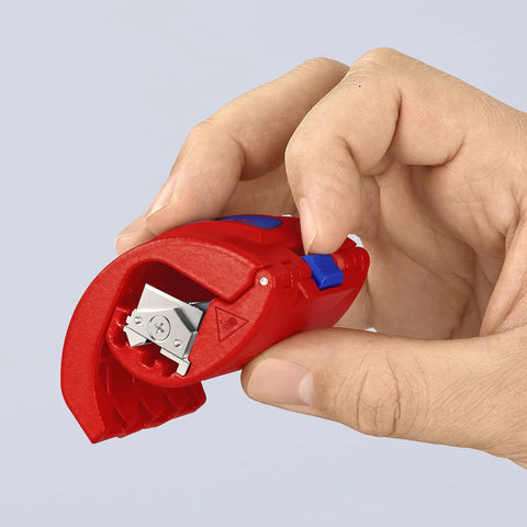 Hand holding BiX Pipe Cutter for 3/4 Inch to 2 Inch Pipes, showing reversible blade head and red and blue handle.