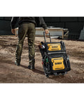 Worker pulling 18 Inch Rolling Tool Bag With 27 Pockets For Rough Jobsites IP54 Water Resistant Compartment Built Tough From 1680D Fabric