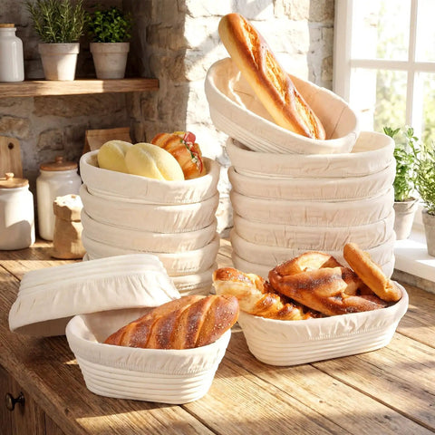 30 Set Bulk Oval Banneton Bread Proofing Baskets With Cloth Liners Natural Rattan Dough Bowls Kit For Sourdough Baking At Home 8.3 Inch And 9.8 Inch Sizes Ideal For Home Bakers stacked on a kitchen counter with fresh bread.