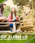 Outdoor scene with backpack, thermos, and map beside people, showcasing Quad 3.0 12 Gauge Perimeter Trip Alarm System With 209 And.22 Adapters
