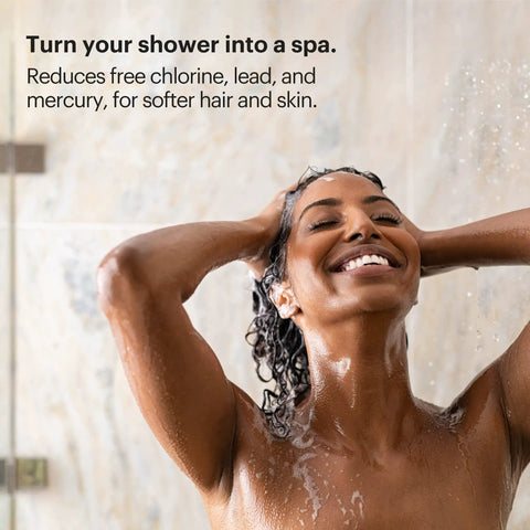 Woman enjoying shower with VivaSpring Compact Shower Filter, healthier skin and hair, brushed nickel, high output KDF filtration.