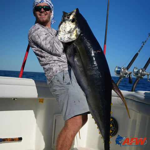 Angler holding a large fish on a boat, showcasing successful use of Pro Grade Copper Crimp Sleeves For Fishing Line.