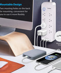 Power Strip Surge Protector With Eight Outlets And Three USB Ports For Fast Charging, wall-mounted near desk setup.