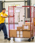 Man moving a rolling cage with boxes, showcasing Badass Smooth Rolling Swivel Caster Wheels With Locking Brakes For Couches Tables And Home Appliances Tough Black Plastic Metal Frame Effortless 360 Spin Four Piece Kit.