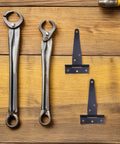 Heavy Duty T-Shaped Iron Door Hinges With Screws for garden gates and big cabinets on wooden surface with tools