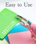 Star Shaped Handheld Paper Hole Punch With Soft Grip Pink Silicone Cover showing use on colorful paper for crafts