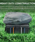 Heavy Duty Outdoor Electrical Junction Box With IP54 Waterproof Shield And Bully Tight Cord Locks For Reliable Extension Cover showing rock on top, grass background.