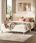 Queen Size Bed Frame With Wingback Headboard Upholstered In Beige Corduroy Fabric in cozy bedroom setting with decorative pillows.