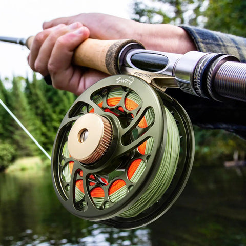 Person fly fishing with Preloaded Sword Fly Fishing Reel With Line CNC Machined Aluminum Alloy 5/6Wt Olive Green on rod.