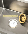 Gold 3.5-Inch Kitchen Sink Drain Assembly with Removable Strainer Basket and Stopper next to stainless steel sink opening