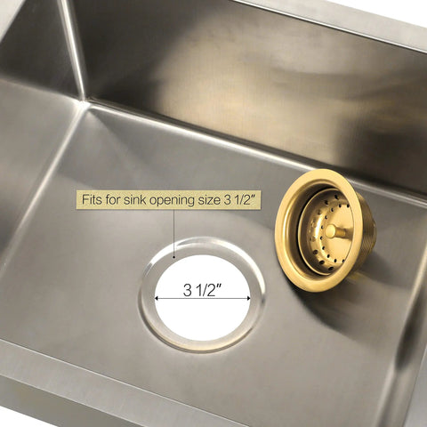 Gold 3.5-Inch Kitchen Sink Drain Assembly with Removable Strainer Basket and Stopper next to stainless steel sink opening