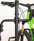 Close-up of a Freestanding Four Bike Storage Rack With Adjustable Gravity Hanger holding two bikes, easy installation, no wall drilling.
