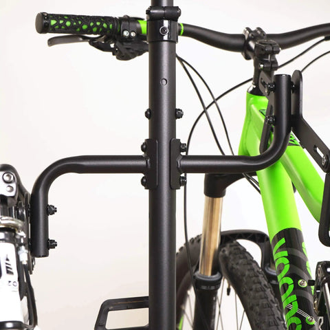 Close-up of a Freestanding Four Bike Storage Rack With Adjustable Gravity Hanger holding two bikes, easy installation, no wall drilling.
