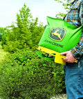 Person holding a 25 Lb Handheld Bag Seeder Spreader With Waterproof Vinyl Bag, Enclosed Gears, Adjustable Shoulder Strap