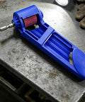 Heavy Duty Angle Grinder And Saw Cutter Featuring Field Ready Drill Bit Sharpening Tool with blue sanding attachment on metal surface.