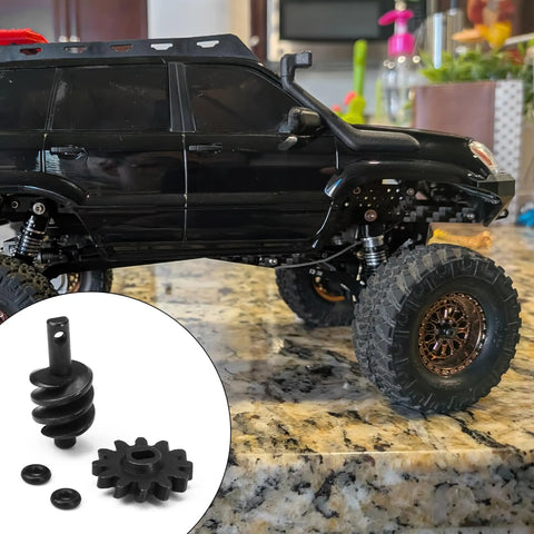Overdrive Helical Gear Set 2-12T For 1/24 Axial SCX24 Crawler Upgrades With Steel Worm Gears next to RC crawler on table