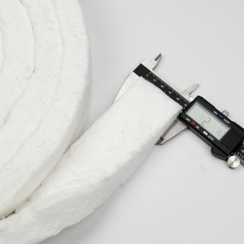 Strip ceramic fiber blanket, white; 2 in thick by 1 in wide by 150 in long, shown with calipers