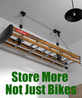 Ceiling Mount Bike Hoist With 100 Lb Capacity Overhead Storage For All Bike Types From E Bikes To Fat Tires Ideal Garage Or Workshop Space Saver Lift Your Ride Off The Floor And Free Up Cubic Footage installed on ceiling, wooden base, black pulleys