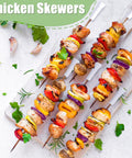 Colorful chicken skewers with vegetables on white background, garnished with herbs.