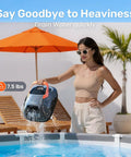 Woman lifting LiteVac 800 Robotic Pool Cleaner with 1200 GPH suction, 90 minute run time, lightweight 7.5 lb near poolside.