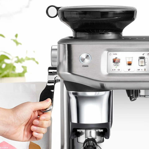 Certified Remanufactured Automatic Espresso Machine With Built In Grinder And Steam Wand, close-up view with power button.