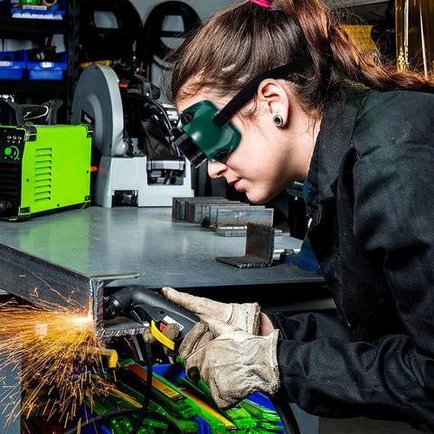 Premium Flip Up Welding Goggles With Soft Comfort Frame And Adjustable Headband Dustproof Industrial Safety Glasses Built Like A Tank For The Shop Tough As Nails Protection You Deserve worn by a worker in a workshop using a welding tool.