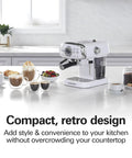 Kickstart Your Morning Grind With This Retro White Espresso Machine on a countertop with coffee cups, pastries, and fruit.